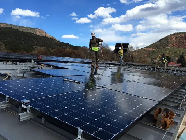 Workers installing solar panels